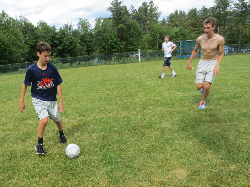 Another batch of boys were engaged in that surely appears to be a normal game of soccer...