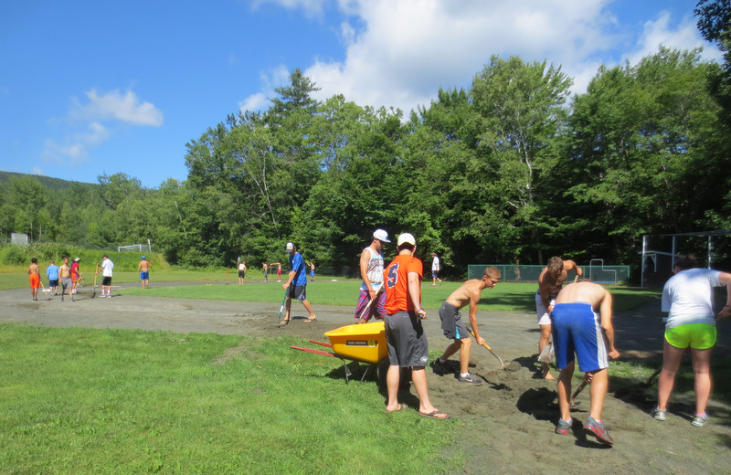 While the campers were off to the Whale's Tale Water Park yesterday, this forced conscription team repaired the ball field erosion caused by the heavy downpours of last week.  